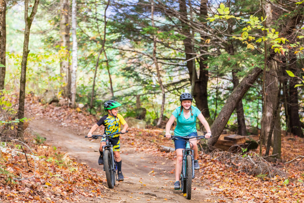 Kids mountain biking on a trail behind Mountain Valley High School in Rumford, Maine.